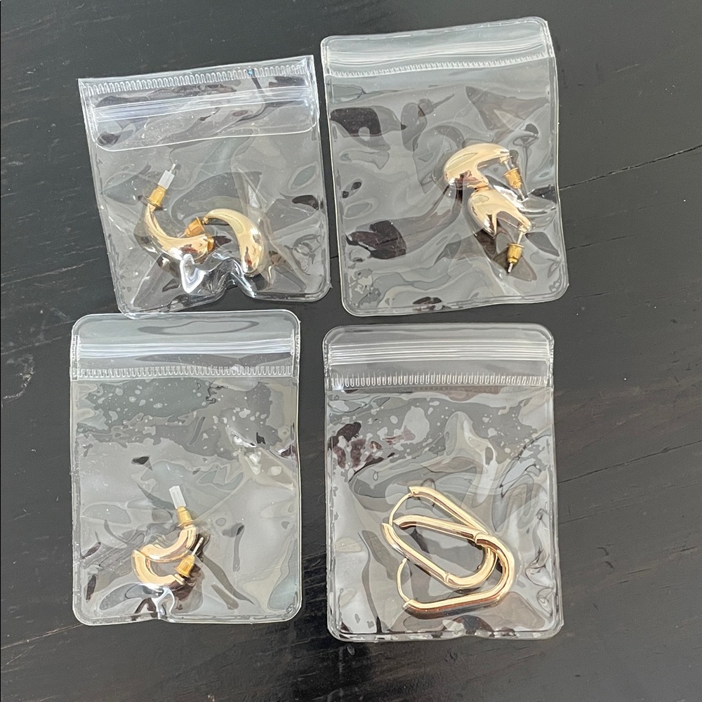 Set of four pairs of gold tone earrings